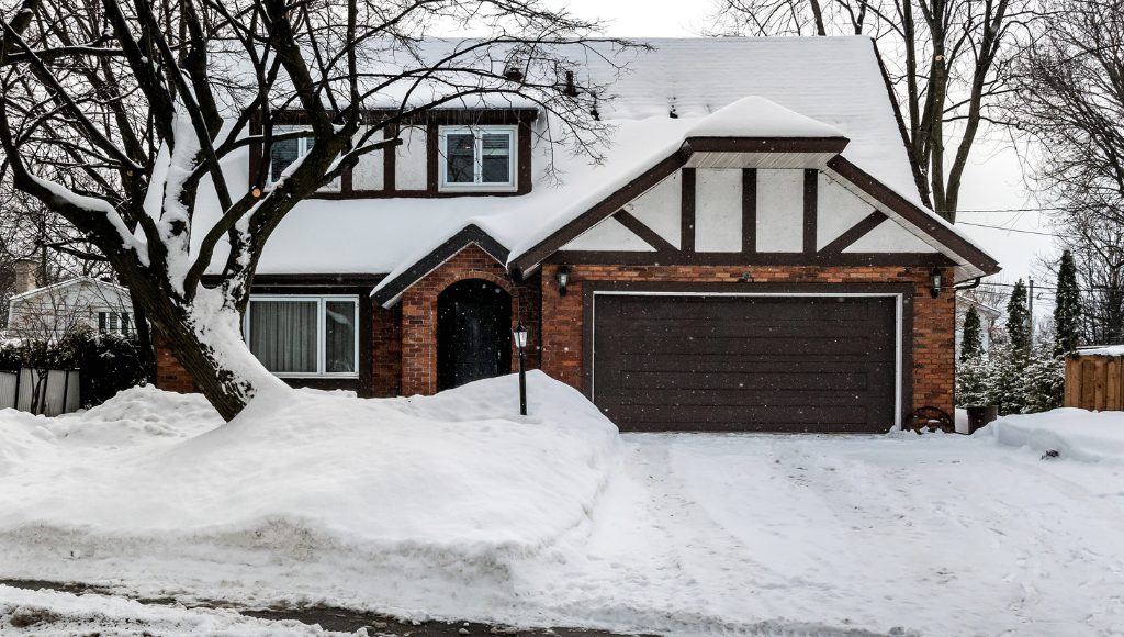 The front of a house in Central New York covered in snow.