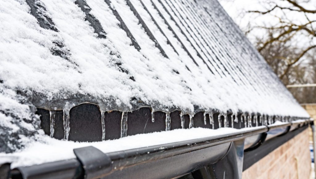 House gutter filled with snow and ice.