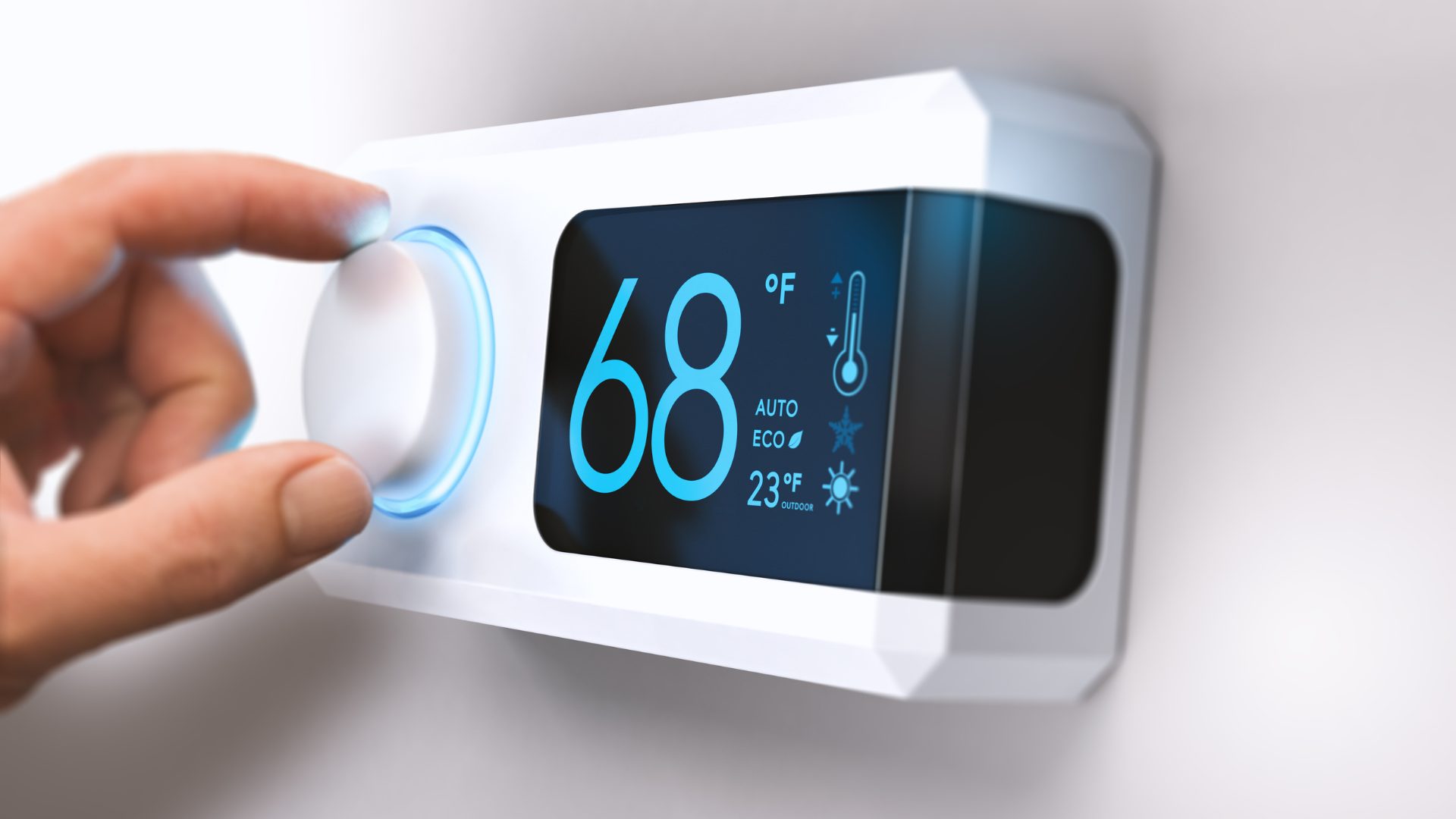 A hand adjusting a smart thermostat on a wall to 68F