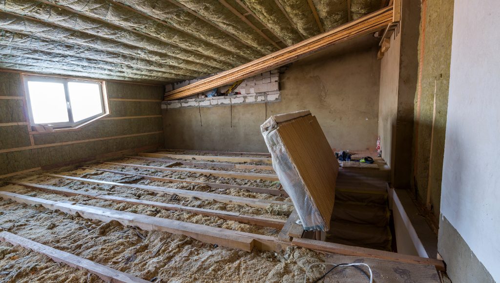 Exposed insulation in an attic.