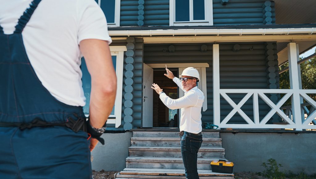 Home inspector a hard hat assesses a home.
