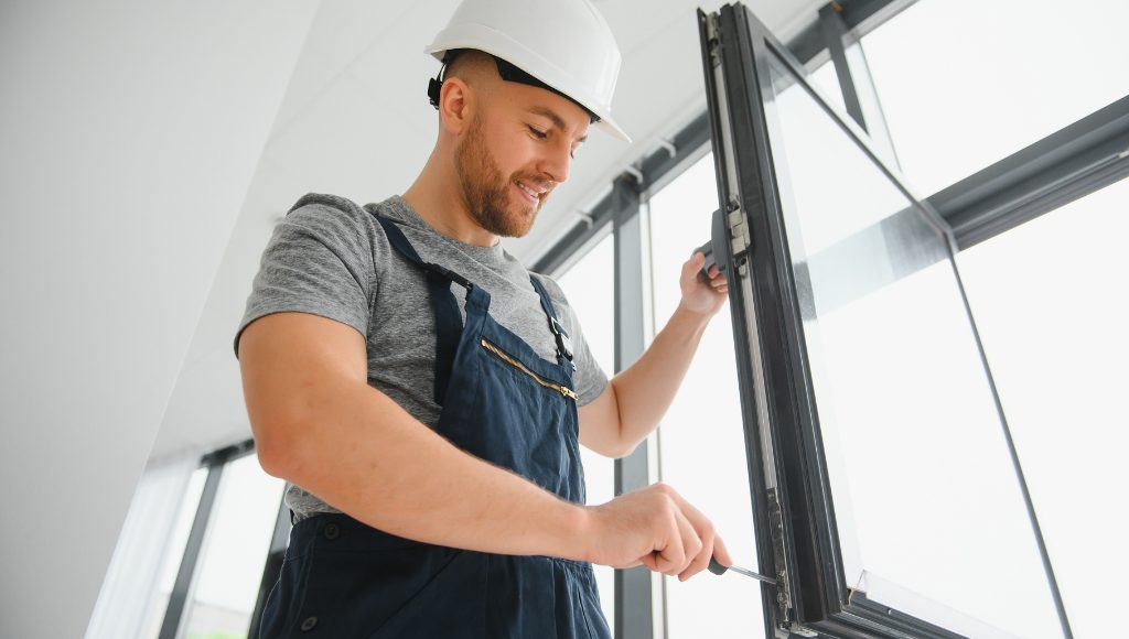 A professional installs a new energy-efficient window in a light-filled home.